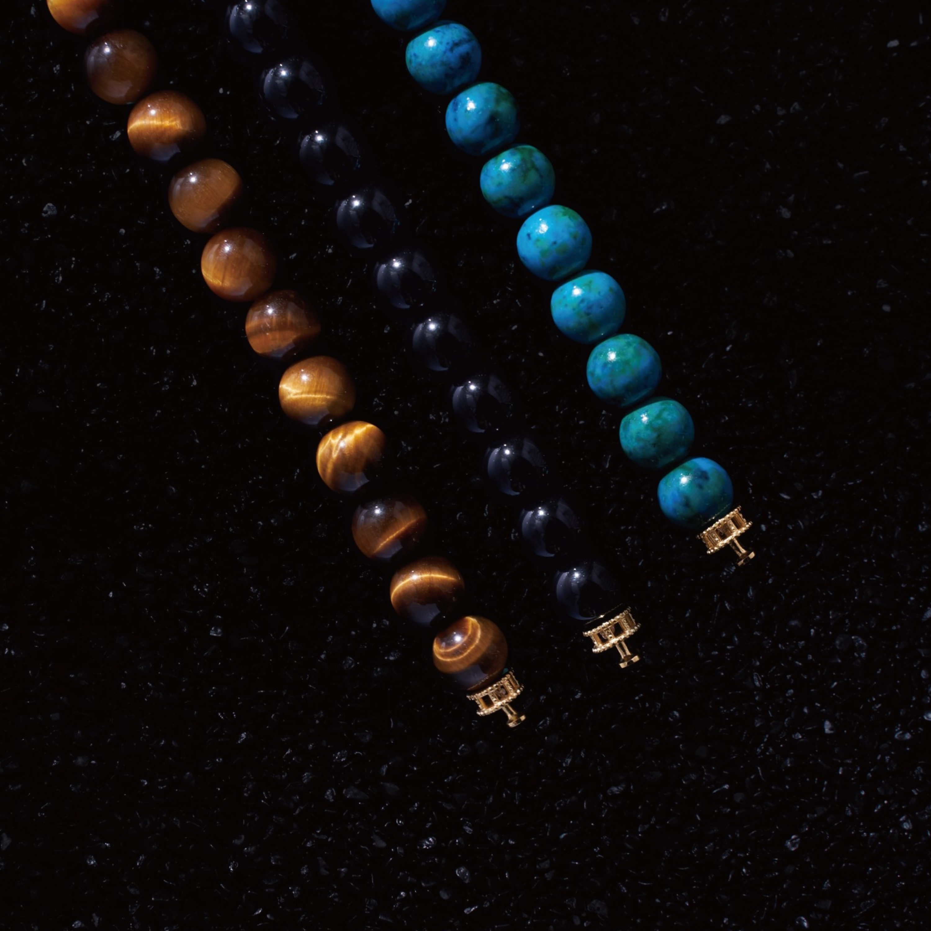 Selected three men's beaded bracelets, obsidian, turquoise, and tiger eye match perfectly with Azuro Republic gold charm beads. The beaded bracelets cover the main color choices for men, black, blue, brown, and portrait a subtle gentleman look.
