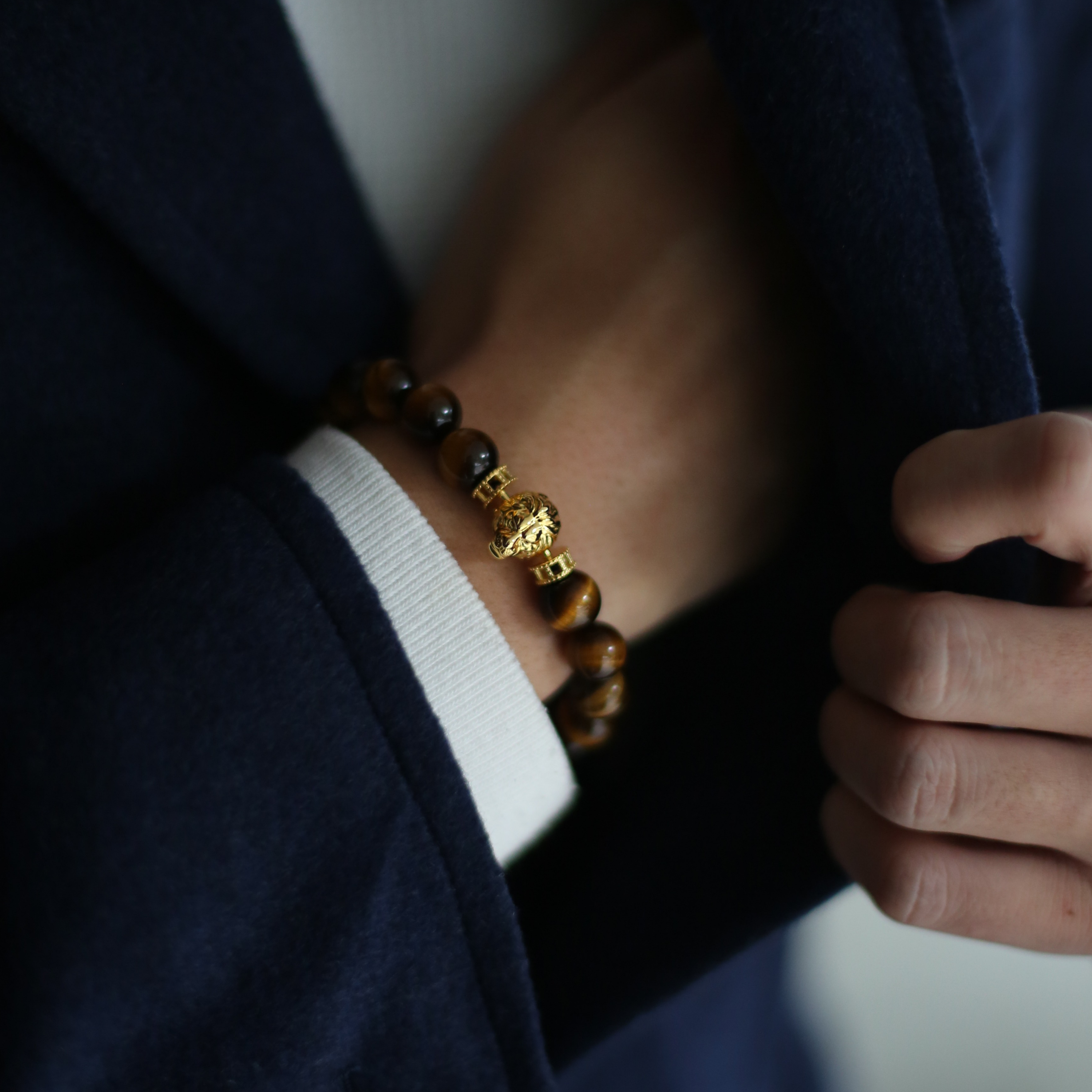 Gold lion bracelet is a clip bracelet mixing with Tiger Eye crystal. This men's beaded bracelet is a sophisticated handcrafted bracelet with a masculine gold lion charm. Tiger eye crystal attracts positivity. If you are looking for a custom men's beaded bracelet, you can learn more from our gemstone crystal beaded bracelet collection.