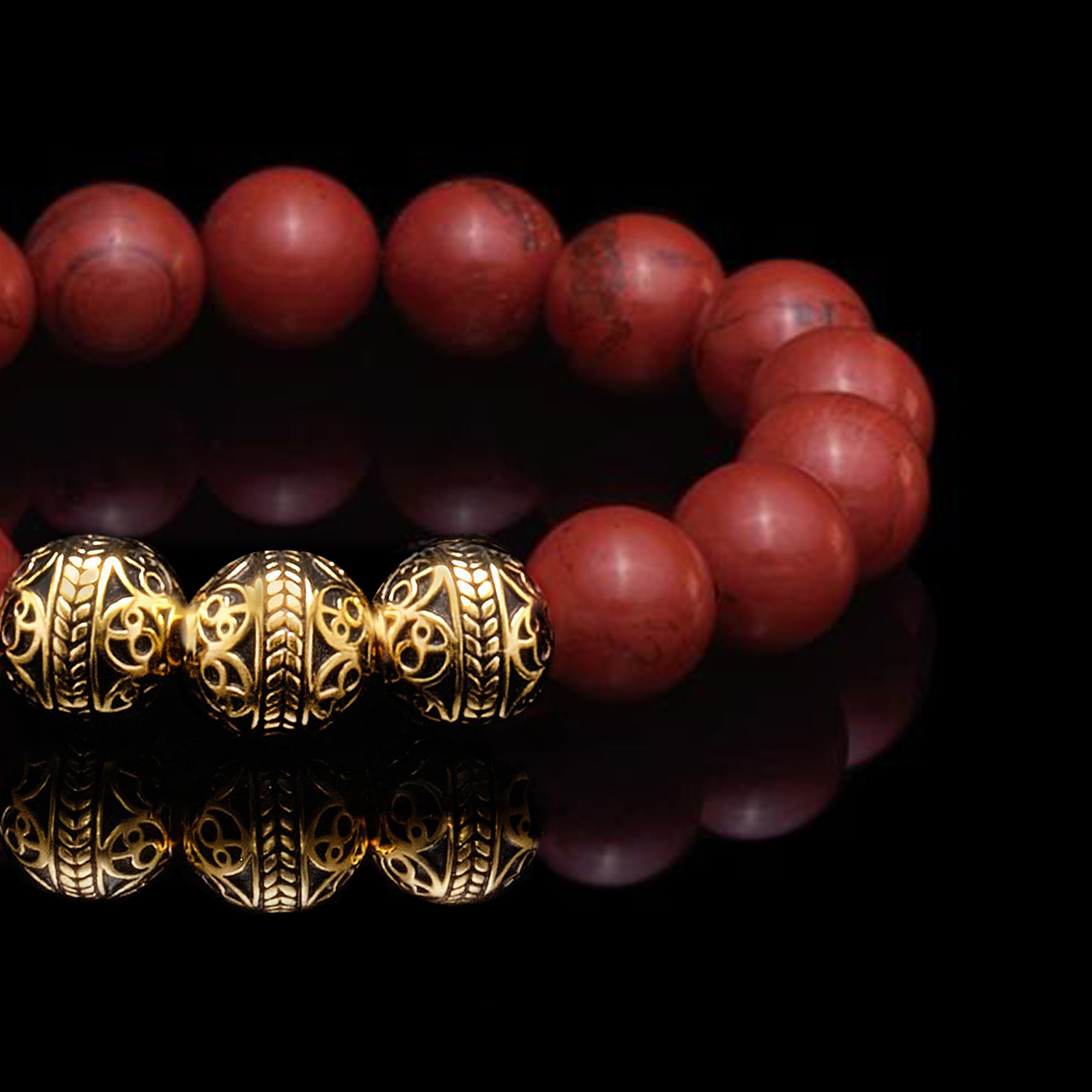 The Red Jasper stones combine with 24k Gold Plated Beads make up the Gold Classic Red Jasper Bracelet that symbolizes dedication and diligence. The red jasper stones owes its blush to its iron impurities, and radiate a blood hue that provokes a passionate emotion. The Red Jasper bracelet for men infuses its gemstone healing properties into its base and sacral chakras, and this passion leads to a path of excellence.