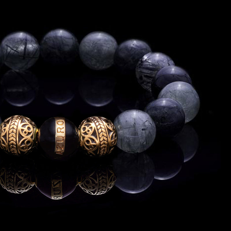The Gold Enamel Black Gaia bracelet is consisted of Black Rutilated Quartz and 3 Microns 24k Gold Plated Beads, which can assist you to have a calm and collected mind, making you to see things clearer and solve the trials and tribulations in life with ease. With the Greek goddess Gaia symbolizing existence and balance, this bracelet for men helps bring harmony to life.