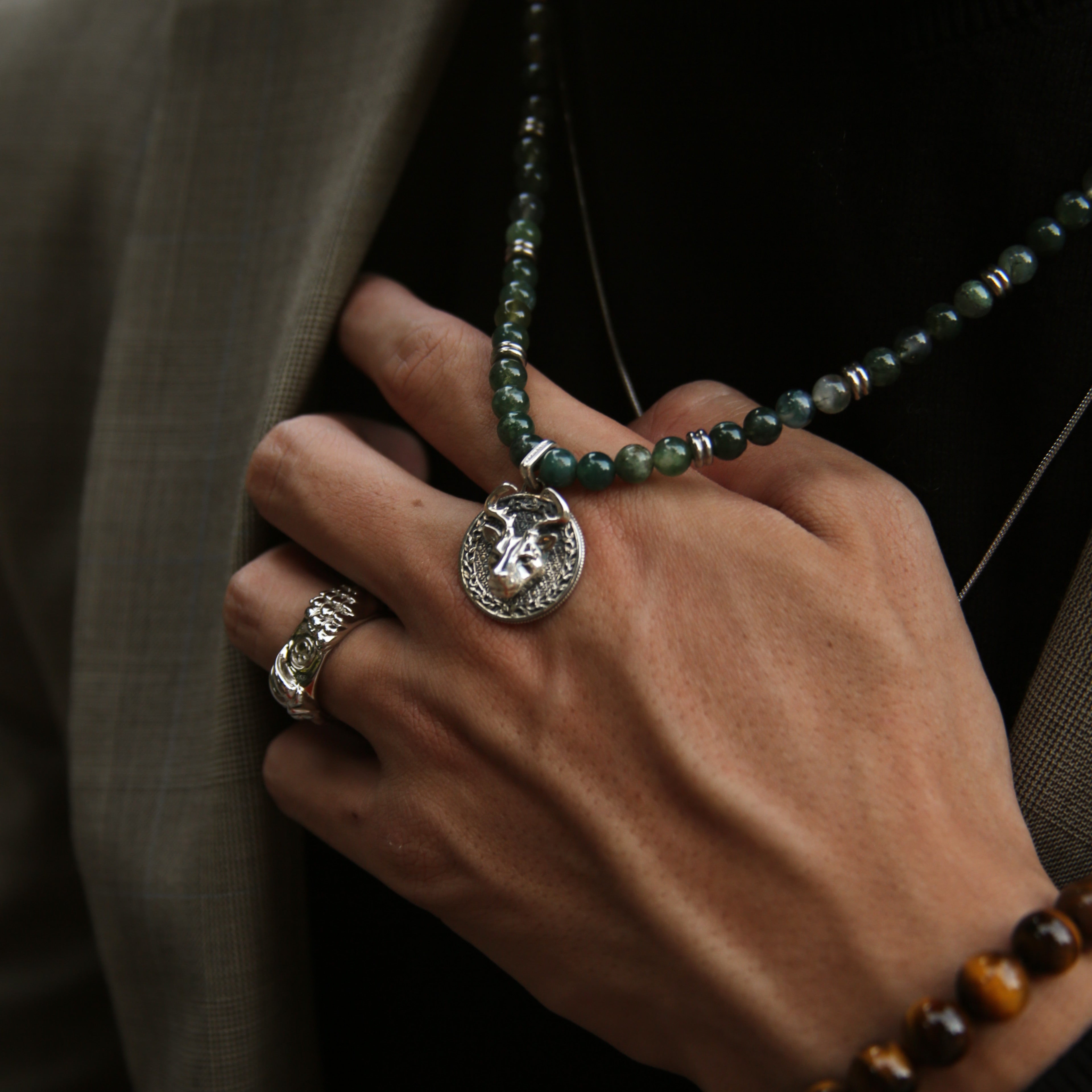 Know as the Green Moss Agate. One of the rarest agate crystals. Put 3 different tonalities of green Agate showcasing the richness of its presentation. Silver pendant necklace for men in green Agate has a gentle, sophisticated touch, and green Agate necklace releases stress and anxiety.