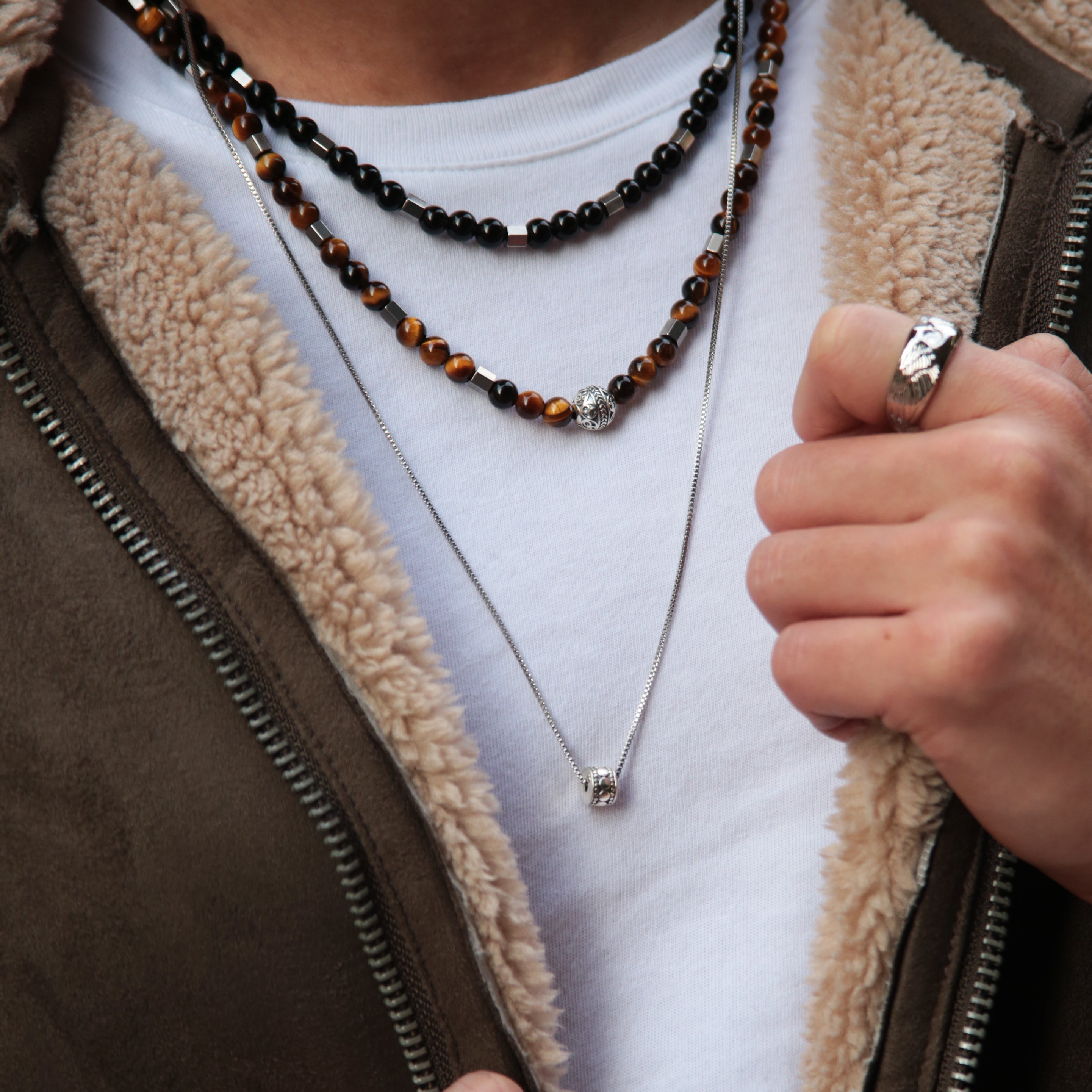 Men's necklace is one of the most popular accessories for men. Silver necklaces with beads or designs can represent the unique styles for men. Custom silver men necklace with handcrafted silver jewelry is sophisticated and stylish. With a stainless steel necklace, you can custom your men's necklace.