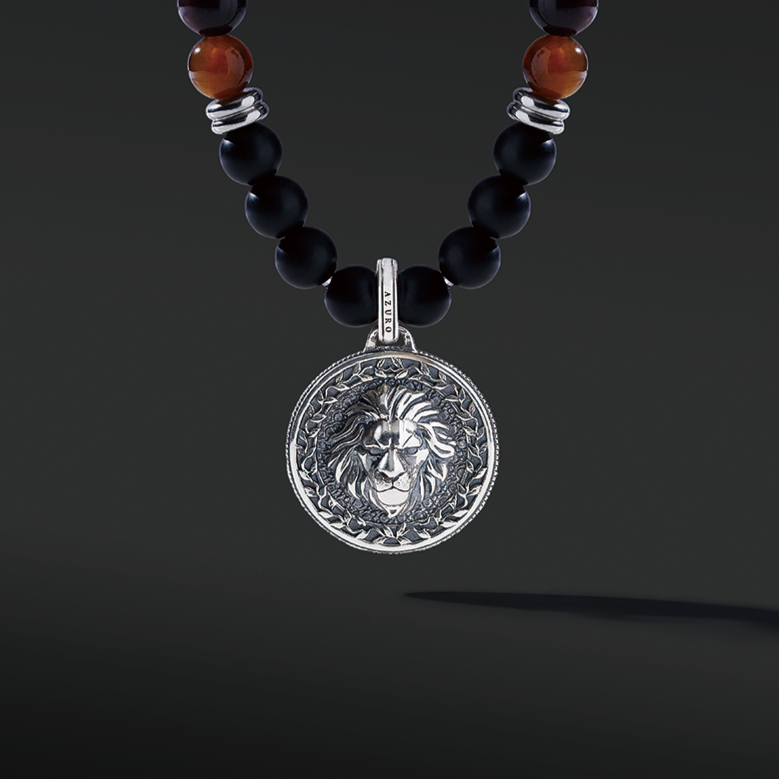 Red Tiger Eye beaded pendant necklace brings wealth and luck. A set of Obsidian crystals highlights the detail of the silver pendant. Mix red Tiger eye beads and Obsidian beads and bring in healing properties of protection and prosperity. Silver pendants for men in oxidization showcase masculinity.