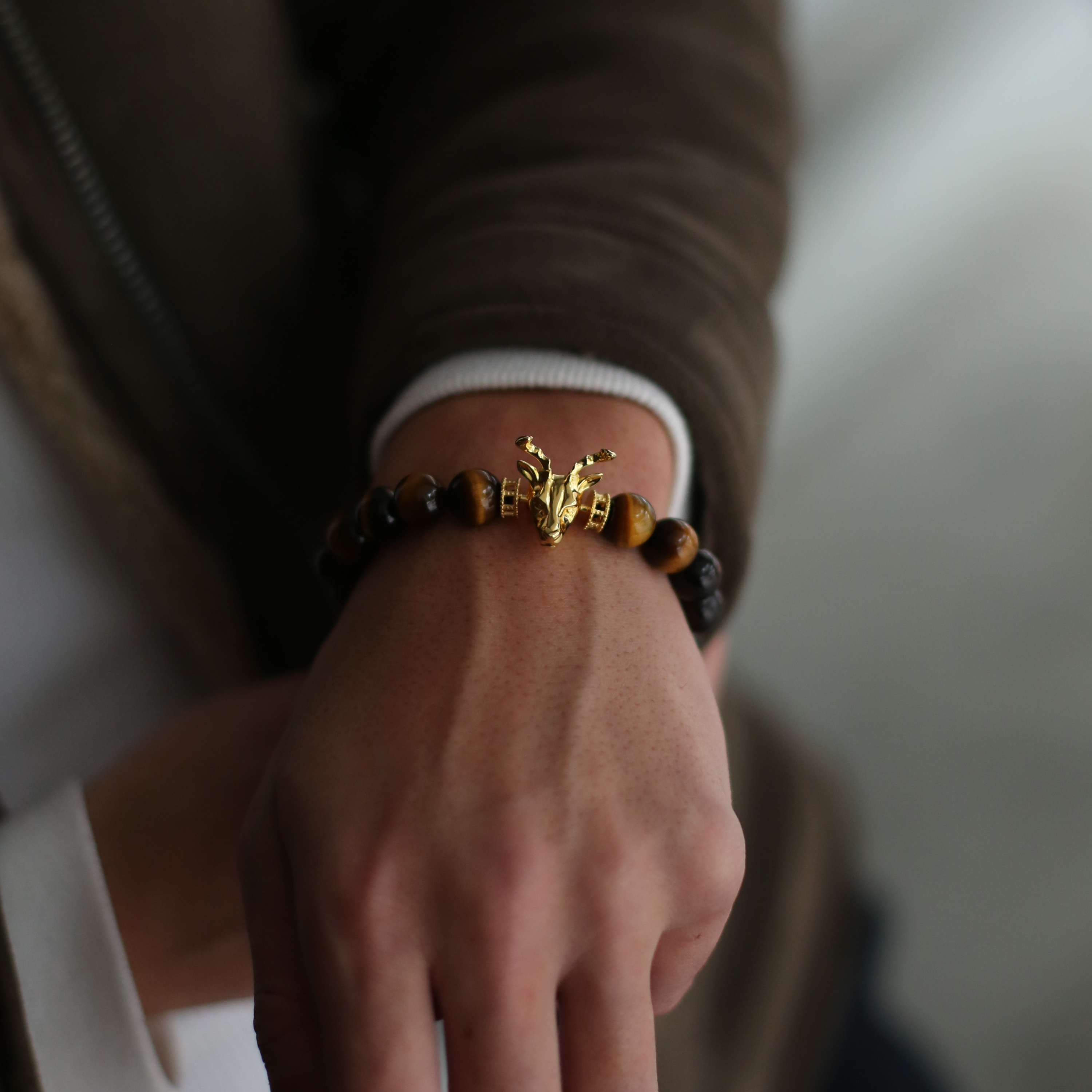 Selected three men's beaded bracelets, obsidian, turquoise, and tiger eye match perfectly with Azuro Republic gold charm beads. The beaded bracelets cover the main color choices for men, black, blue, brown, and portrait a subtle gentleman look. 