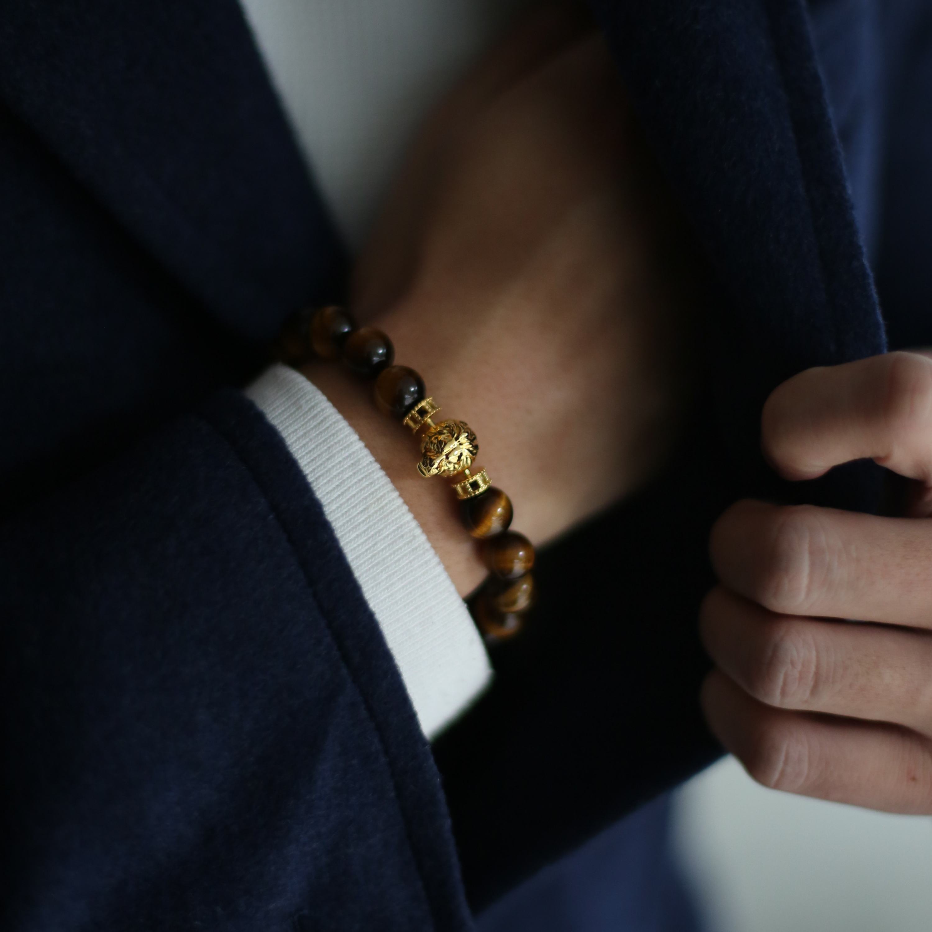 Gold lion bracelet is a clip bracelet mixing with Tiger Eye crystal. This men's beaded bracelet is a sophisticated handcrafted bracelet with a masculine gold lion charm. Tiger eye crystal attracts positivity.  If you are looking for a custom men's beaded bracelet, you can learn more from our gemstone crystal beaded bracelet collection. 