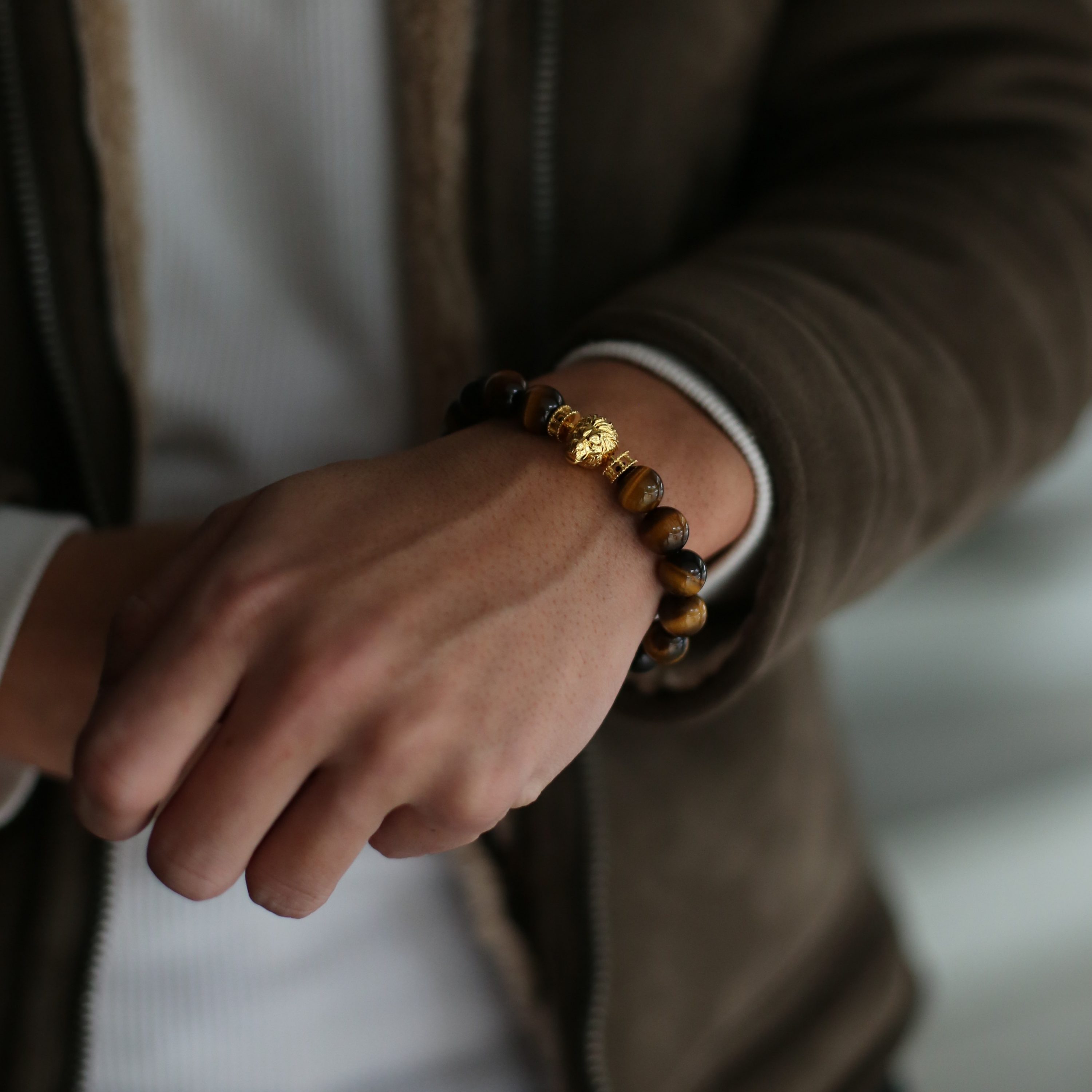 Gold lion bracelet is a clip bracelet mixing with Tiger Eye crystal. This men's beaded bracelet is a sophisticated handcrafted bracelet with a masculine gold lion charm. Tiger eye crystal attracts positivity.  If you are looking for a custom men's beaded bracelet, you can learn more from our gemstone crystal beaded bracelet collection. 