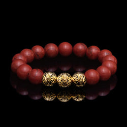 The Red Jasper stones combine with 24k Gold Plated Beads make up the Gold Classic Red Jasper Bracelet that symbolizes dedication and diligence. The red jasper stones owes its blush to its iron impurities, and radiate a blood hue that provokes a passionate emotion. The Red Jasper bracelet for men infuses its gemstone healing properties into its base and sacral chakras, and this passion leads to a path of excellence.