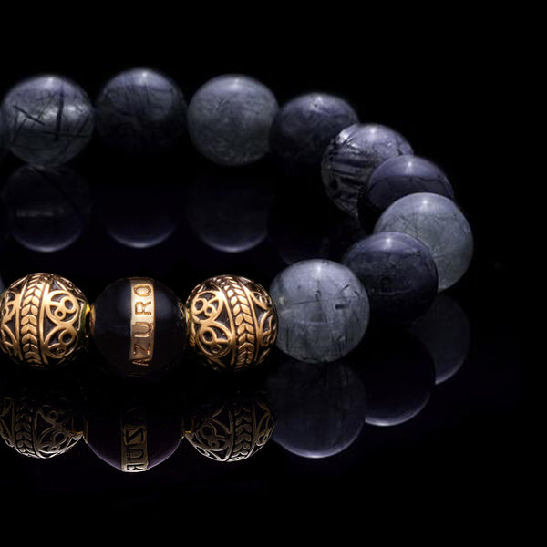 The Gold Enamel Black Gaia bracelet is consisted of Black Rutilated Quartz and 3 Microns 24k Gold Plated Beads, which can assist you to have a calm and collected mind, making you to see things clearer and solve the trials and tribulations in life with ease. With the Greek goddess Gaia symbolizing existence and balance, this bracelet for men helps bring harmony to life.
