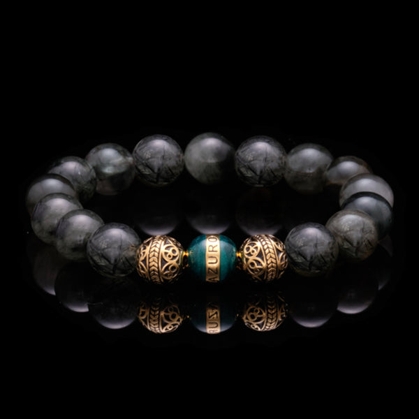 The Gold Enamel Turquoise Gaia bracelet is consisted of Black Rutilated Quartz and 3 Microns 24k Gold Plated Beads, which can assist you to have a calm and collected mind, making you to see things clearer and solve the trials and tribulations in life with ease. With the Greek goddess Gaia symbolizing existence and balance, this bracelet for men helps bring harmony to life. 