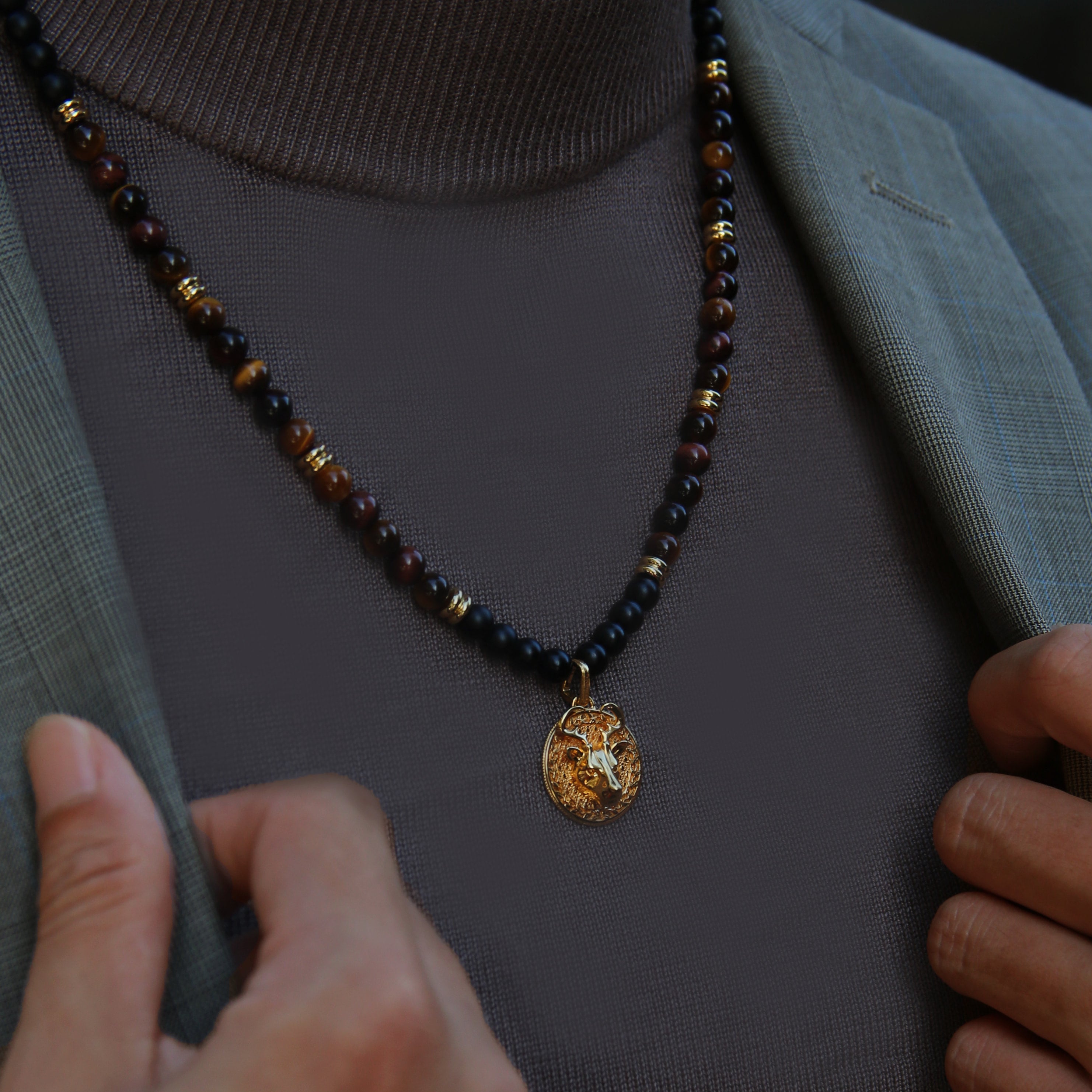 Tiger Eye beaded pendant necklace brings wealth and luck. A bottom set of Obsidian crystals highlights the detail of the silver pendant. Tiger Eye, Obsidian crystals amplify the healing properties of protection and prosperity. Azuro gold pendants provide options to complete all whole styles. Explore your gold pendant necklaces with us.