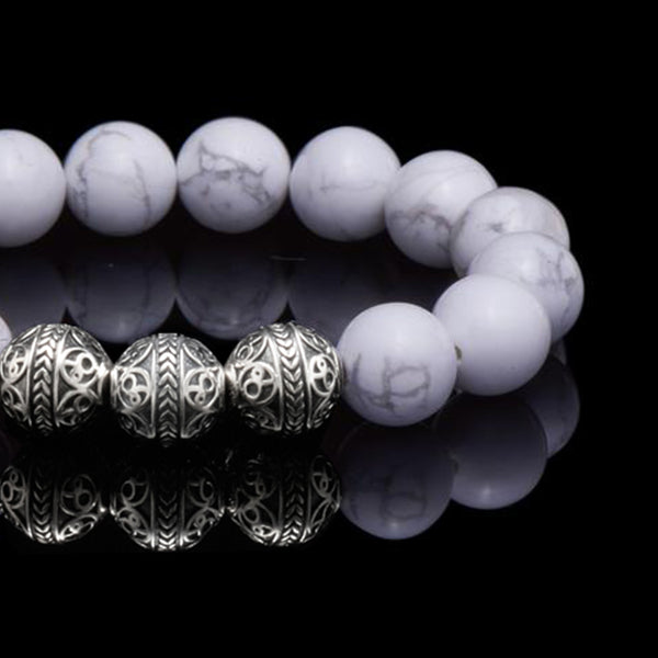 Howlite is a marble patterned borate mineral, and in its natural form presents a beautiful white crystal finished with delicate grey veins. The Howlite bracelet can bring clarity, facilitates awareness and stimulates desire for knowledge. The calming healing power of the Howlite stone will induce internal serenity and while compiling one’s outfit, simultaneously providing a classy gentleman look. 