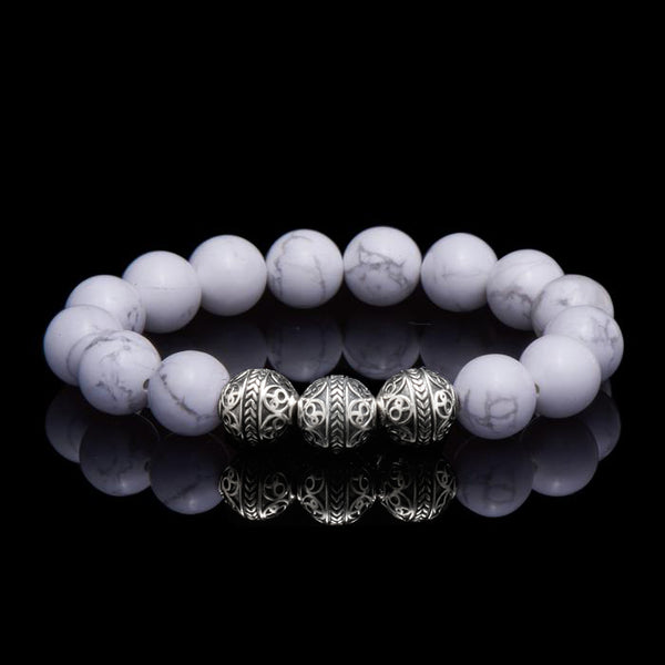 Howlite is a marble patterned borate mineral, and in its natural form presents a beautiful white crystal finished with delicate grey veins. The Howlite bracelet can bring clarity, facilitates awareness and stimulates desire for knowledge. The calming healing power of the Howlite stone will induce internal serenity and while compiling one’s outfit, simultaneously providing a classy gentleman look. 